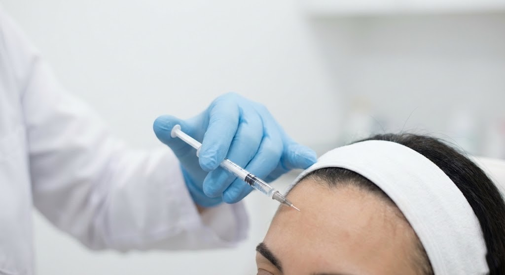 close up of doctor performing Botox injection on forehead at Dubai aesthetic clinic